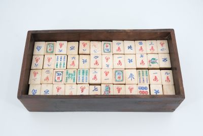 an old wooden box filled with wooden tiles with chinese writing
