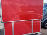 a red box truck parked in a parking lot