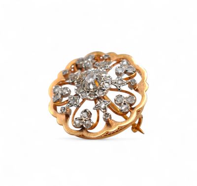 an image of a close up of a gold and diamond broochle