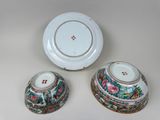 three pieces of chinese porcelain are sitting on a white surface