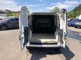 a white van with its doors open in a parking lot