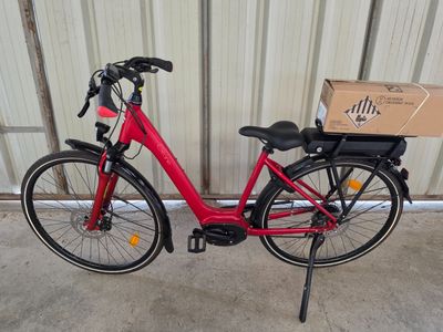 a red bike with a box on the back of it