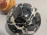 two marble balls sitting next to each other on a table