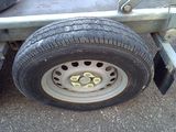 a flat tire on a trailer that is parked on the street
