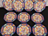six blue and orange plates with flowers on them on a table