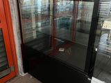 a glass display case in the corner of a store