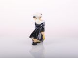a small figurine of a woman in a black dress