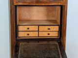 a small wooden cabinet with two drawers on top of it