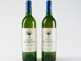 two bottles of wine sitting next to each other on a white surface