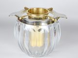 an image of a silver and glass vase with a gold handle