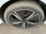 a close up of a tire on a white car