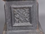 a close up of a statue of a bird on a pedestal