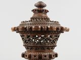 an old wooden lamp with a decorative design on the top of it