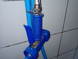 a blue hose attached to a shower head in a bathroom