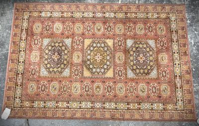 an antique persian rug with a medallion design on a red ground