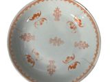 an orange and white plate with a design on it