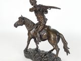 bronze statue of a man on a horse with a spear on his head