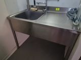 a sink and a refrigerator in a small room