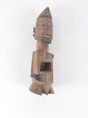 an image of a wooden statue of a man with a hat on