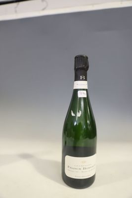 a bottle of champagne sitting on a counter top