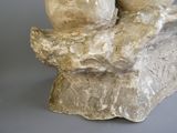 a sculpture of a man and woman sitting on a rock