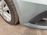 a close up of a car ' s front bumper and tire