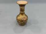 pair of antique brass vases on a glass table
