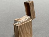 a gold lighter that is sitting on a table