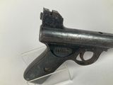 an old gun that is on display on a white surface