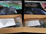 two boxes of star trek voyager and a box of star trek voyager