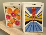 two boxes of oranges on a table with a picture of a woman