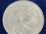 a close up of a silver coin on a blue cloth