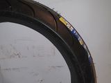a close up of a tire on a table with a wall in the background