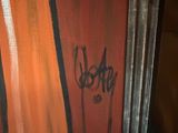 graffiti on the side of a building with a toilet and a toilet paper dispenser