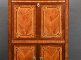 a small cabinet with two doors and a marble top