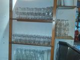 a shelf with glasses on it in a kitchen
