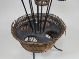 a wicker basket with a bunch of flowers in it