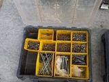 many different tools in a plastic box on the floor