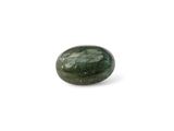 a close up of a green stone on a white surface