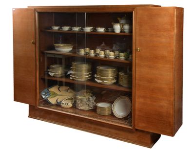 a cabinet that has many plates and bowls in it
