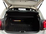 the back of a white car with its trunk open and the back of it ' s trunk open