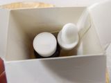 a white container with two bottles inside of it