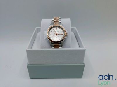 a close up of a watch in a box on a table