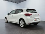the rear end of a white car parked in a garage