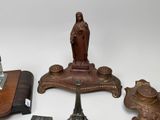 a statue of a woman sitting on top of a table next to other items