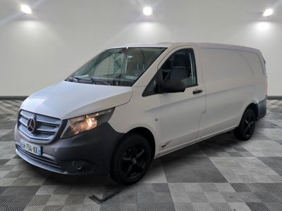 the white van is parked on a checkered floor in a garage