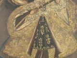 an image of a painting of a man in a golden coat and hat