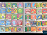 pokemon trading cards in a clear plastic case on a black background