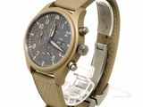 a brown watch with a blue face on a white background