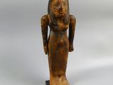 an old wooden statue of a woman holding a bird in her hand